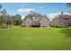 Expansive backyard featuring a well-maintained lawn and brick home with a deck at 2548 Westchester Se Way, Conyers, GA 30013