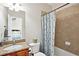 Bathroom with granite counters and shower with a blue patterned curtain at 2548 Westchester Se Way, Conyers, GA 30013