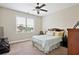 Comfortable bedroom with ceiling fan and view of the outside through a large window at 2548 Westchester Se Way, Conyers, GA 30013