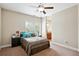 Bedroom with a queen bed and view of the backyard through the window at 2548 Westchester Se Way, Conyers, GA 30013