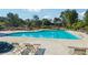 A refreshing community pool with lounge chairs, surrounded by lush greenery and clear skies, inviting relaxation at 2548 Westchester Se Way, Conyers, GA 30013