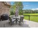 Outdoor deck features seating, a grill, and a view of the green lawn at 2548 Westchester Se Way, Conyers, GA 30013