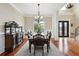 Formal dining room showcasing hardwood floors, an elegant chandelier, and detailed trim work for sophisticated dining at 2548 Westchester Se Way, Conyers, GA 30013