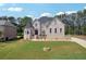 Stunning two-story brick home with a well-manicured lawn and mature trees, offering classic elegance and curb appeal at 2548 Westchester Se Way, Conyers, GA 30013