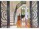 Grand foyer with soaring ceilings, hardwood floors, an ornate staircase, and views into the formal living areas at 2548 Westchester Se Way, Conyers, GA 30013