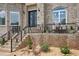 Inviting front porch with elegant iron railings, seating, landscaping, and a decorative front door, perfect for relaxing outdoors at 2548 Westchester Se Way, Conyers, GA 30013