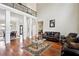 Spacious living room with soaring ceilings, hardwood floors, elegant columns, and comfortable seating arrangements at 2548 Westchester Se Way, Conyers, GA 30013