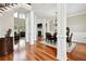 Elegant living room featuring hardwood floors, decorative columns, a fireplace, and large windows for ample natural light at 2548 Westchester Se Way, Conyers, GA 30013