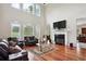 Bright and airy living room with a fireplace, large windows, and comfortable seating for cozy gatherings at 2548 Westchester Se Way, Conyers, GA 30013