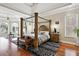 Spacious main bedroom features a four poster bed, large windows, and hardwood floors at 2548 Westchester Se Way, Conyers, GA 30013