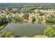 Aerial view of a pond surrounded by lush trees and beautiful neighborhood homes at 2548 Westchester Se Way, Conyers, GA 30013