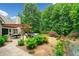 Backyard with a pergola covered patio, lounge seating, manicured plants and a walkway at 3633 Gilpin Ct, Lawrenceville, GA 30044