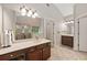 Bright bathroom featuring a vanity with a large mirror, shower, and tile floor at 3633 Gilpin Ct, Lawrenceville, GA 30044