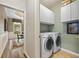 Laundry room featuring a washer, dryer, and overhead cabinets at 3633 Gilpin Ct, Lawrenceville, GA 30044