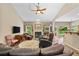 Open living room with fireplace, wood floors, open to kitchen, and plenty of light at 3633 Gilpin Ct, Lawrenceville, GA 30044