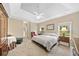 Spacious main bedroom featuring a tray ceiling, neutral colors, and two large windows at 3633 Gilpin Ct, Lawrenceville, GA 30044