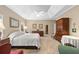 Bright bedroom features a tray ceiling, neutral colors, sitting area, and multiple windows at 3633 Gilpin Ct, Lawrenceville, GA 30044