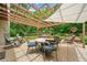 Elegant outdoor patio under a wooden pergola, perfect for dining and lounging with lush green backdrop at 3633 Gilpin Ct, Lawrenceville, GA 30044