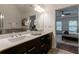 Bathroom featuring double sink vanity with granite countertop and views to the bedroom at 7850 Willoughby Ct, Alpharetta, GA 30005