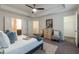 Well-lit main bedroom features a tray ceiling and access to the bath and walk-in closet at 7850 Willoughby Ct, Alpharetta, GA 30005