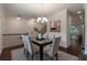Dining area with hardwood floors, modern chandelier, and an open view of the staircase at 7850 Willoughby Ct, Alpharetta, GA 30005