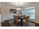 Elegant dining room featuring a modern chandelier, large window, and stylish decor at 7850 Willoughby Ct, Alpharetta, GA 30005