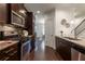 Galley kitchen featuring dark wood cabinets, stainless appliances, and hardwood floors at 7850 Willoughby Ct, Alpharetta, GA 30005