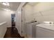 Upstairs laundry room with washer and dryer hookups and wire shelving at 7850 Willoughby Ct, Alpharetta, GA 30005