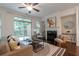 Cozy living room with hardwood floors, fireplace, sliding glass door, and comfortable seating at 7850 Willoughby Ct, Alpharetta, GA 30005