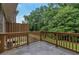 Concrete patio with wood railing overlooking green landscape at 7850 Willoughby Ct, Alpharetta, GA 30005