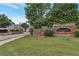 Community entrance sign with brick accents surrounded by lush greenery at 7850 Willoughby Ct, Alpharetta, GA 30005