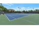 View of tennis courts with a black fence in a neighborhood at 7850 Willoughby Ct, Alpharetta, GA 30005