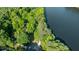 Overhead view of a home on a wooded lot near a lake, showcasing a private and scenic setting at 815 Marshview Close, Roswell, GA 30076