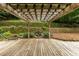 Outdoor deck with pergola overlooking a garden featuring stone details and a waterfall feature at 815 Marshview Close, Roswell, GA 30076