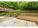 Backyard wooden deck and retaining wall provide an inviting space for entertaining and enjoying the outdoors at 815 Marshview Close, Roswell, GA 30076