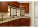 Elegant bathroom with granite counters, dark wood cabinets, dual sinks, and decorative lighting at 815 Marshview Close, Roswell, GA 30076