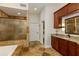 Lavish bathroom featuring granite countertops, wood cabinetry, stone tile, and glass shower at 815 Marshview Close, Roswell, GA 30076