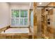 Relaxing bathroom showcases soaking tub, glass shower, and windows offering natural light at 815 Marshview Close, Roswell, GA 30076