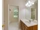 Bathroom featuring a vanity with storage and a mirror, with a view into the shower and toilet area at 815 Marshview Close, Roswell, GA 30076