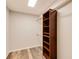 Walk-in closet with wood-look flooring, ample storage, and dark wood organizers at 815 Marshview Close, Roswell, GA 30076