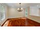 Elegant dining room featuring hardwood floors, a chandelier, and natural light from large windows at 815 Marshview Close, Roswell, GA 30076