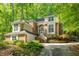 Elegant two-story home featuring brick and stucco with a lush landscaped front yard at 815 Marshview Close, Roswell, GA 30076