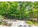 A lake view property with a long driveway and mature trees offering seclusion and natural beauty at 815 Marshview Close, Roswell, GA 30076