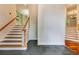 Inviting foyer with slate tile, hardwood stairs, and a view into other rooms at 815 Marshview Close, Roswell, GA 30076