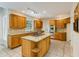 Well-lit kitchen with wooden cabinets, granite countertops, island cooktop, and stainless appliances at 815 Marshview Close, Roswell, GA 30076