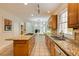 Bright kitchen featuring granite counters, cooktop island, tile floor, and stainless appliances at 815 Marshview Close, Roswell, GA 30076