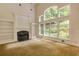 Bright living room featuring a fireplace, built-in shelving, and large windows offering lots of natural light at 815 Marshview Close, Roswell, GA 30076