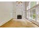 Bright living room featuring a fireplace, built-in bookcases, and large windows with natural light at 815 Marshview Close, Roswell, GA 30076