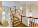 Staircase featuring wood treads, white risers, and a white wood railing leading to an upstairs area at 815 Marshview Close, Roswell, GA 30076