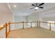 Upstairs area with views of multiple ceiling fans, white railings, and access to several rooms at 815 Marshview Close, Roswell, GA 30076